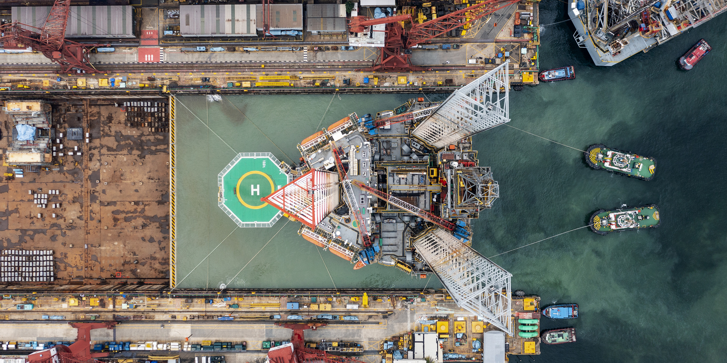 An aerial view of an oil rig with a helicopter pad that has seen transportation and offshore oil rig accident.