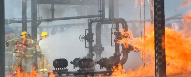 Group of firefighters at an oil field site -consulting with work injury lawyers for work accidents.