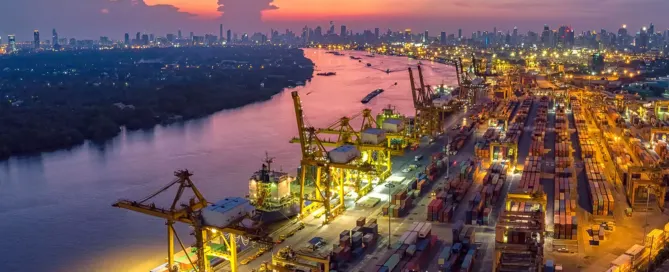 A photo of cargo ships in a harbor with cranes in the background, with the caption "Maritime law and its application to shipping and port operations".