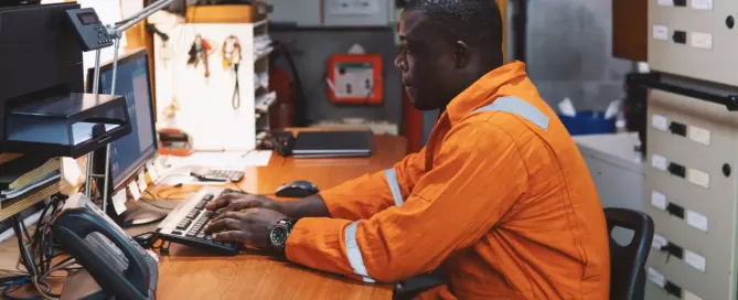 Offshore worker using a computer inside of a vessel