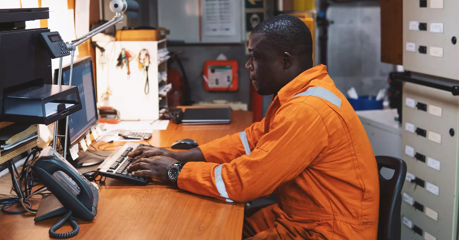 Offshore worker using a computer inside of a vessel