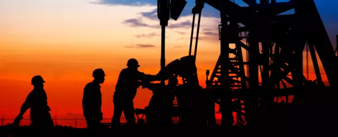 Oilfield workers extracting the oil using heavy equipment - preventing oilfield explosion or fire.