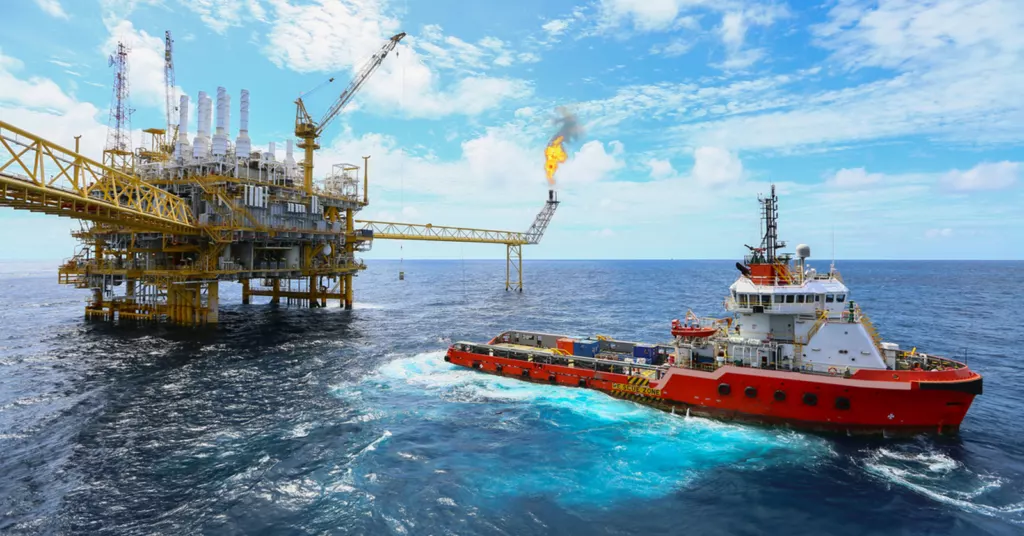 Offshore drilling for oil - Large ship delivering essential oil drilling equipment.